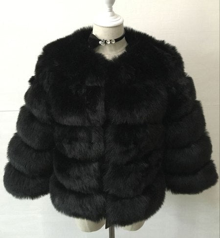 Women’s black fur jacket with large rounded collar and horizontal layered stripes.