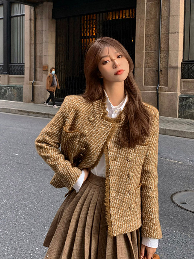 Tweed woolen jacket with gold button front and long sleeves; pleated skirt styling