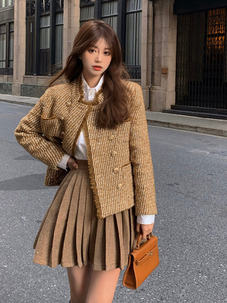 Tweed woolen jacket, long sleeves, gold buttons; styled with a pleated skirt