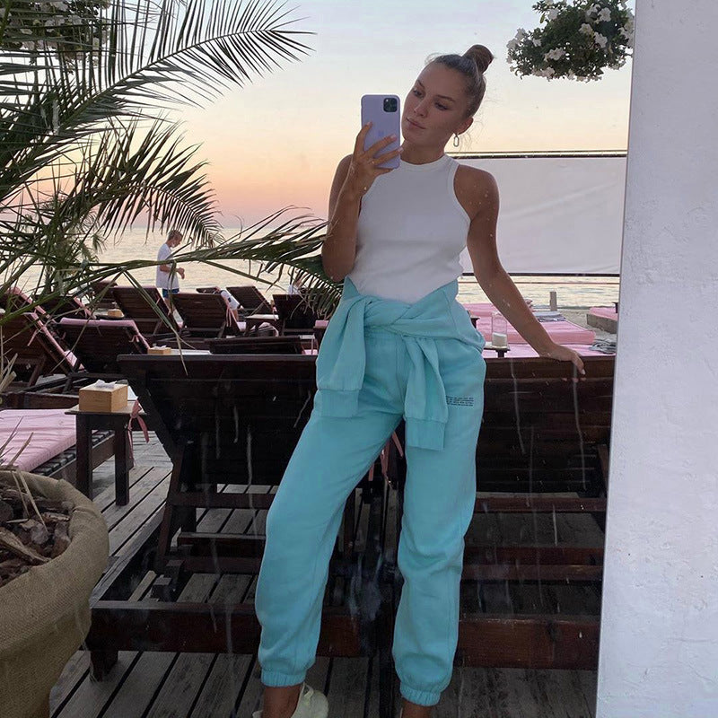 Light teal loose jogger pants with gathered cuffs and relaxed fit