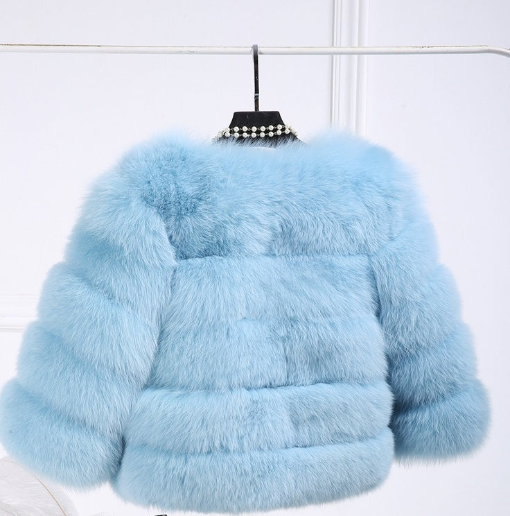 Women’s light blue fur cropped jacket on hanger with wide collar and puff layers.