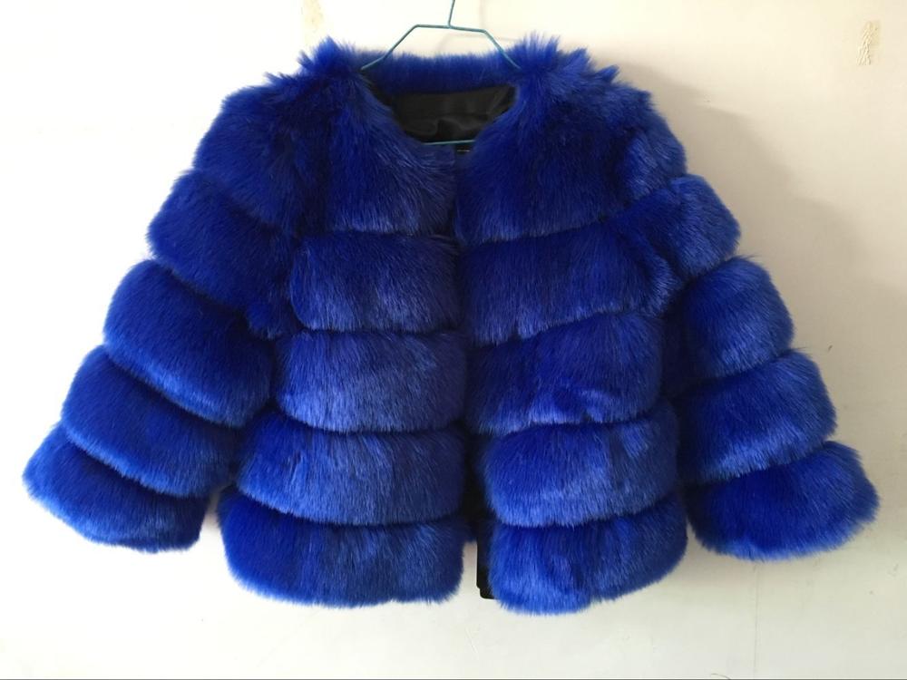 Women’s blue fur cropped jacket with wide collar and thick horizontal layered bands.